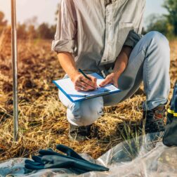 Soil Test. Female agronomist taking notes in the field. Environmental protection, organic soil certification, research